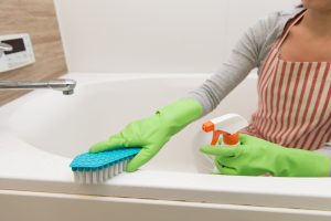 Cleaning bathtub with a brush 